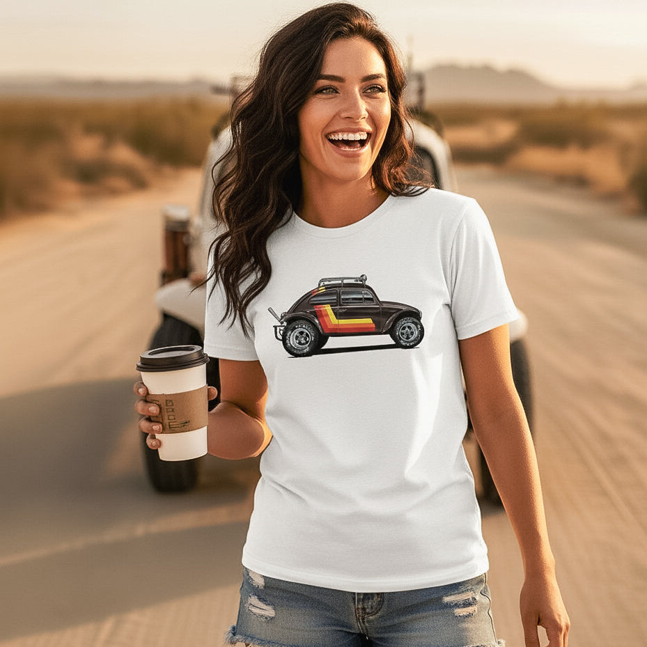 Woman standing in a desert with a vintage Baja bug in the background, wearing a 'Stripes' Baja Bug T-shirt.
