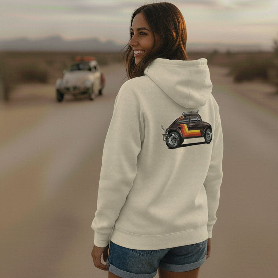 Woman stands in front of a VW Baja Bug wearing a 'Stripes' Baja Bug hoodie in off white.