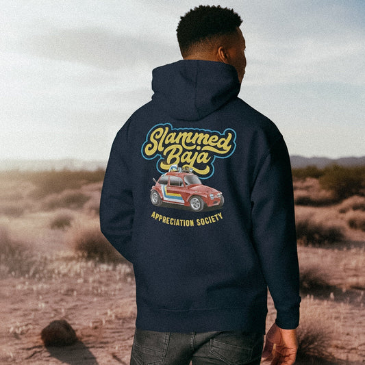 Man wearing a navy hoodie with 'Slammed Baja Appreciation Society' graphic in a desert setting